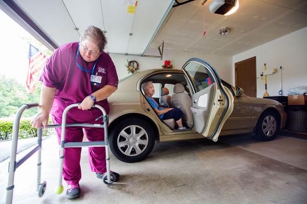 Seniors Home Care's Denise Tuttle helps Rose Marie Westermann out of her car at home.